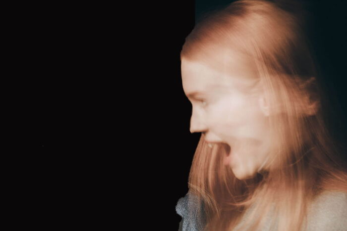 Eine Frau schreit erschreckt laut auf. Sie scheint etwas zu sehen, dass ihr große Angst macht.